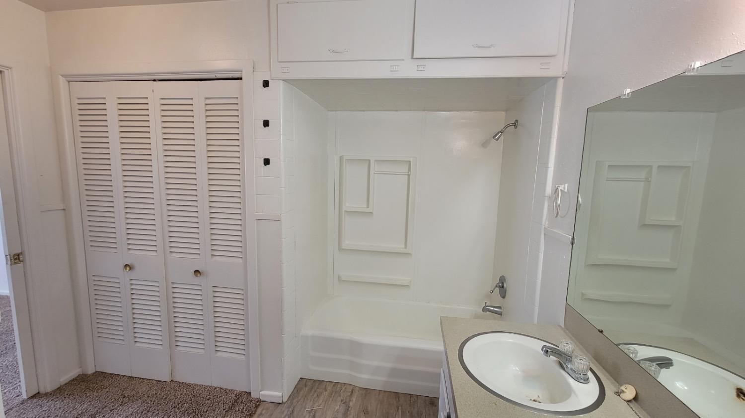 4205 50th Street, Unit A Lubbock, TX 79413 - Photo 3 of 10 a bathroom with a granite countertop sink toilet and shower