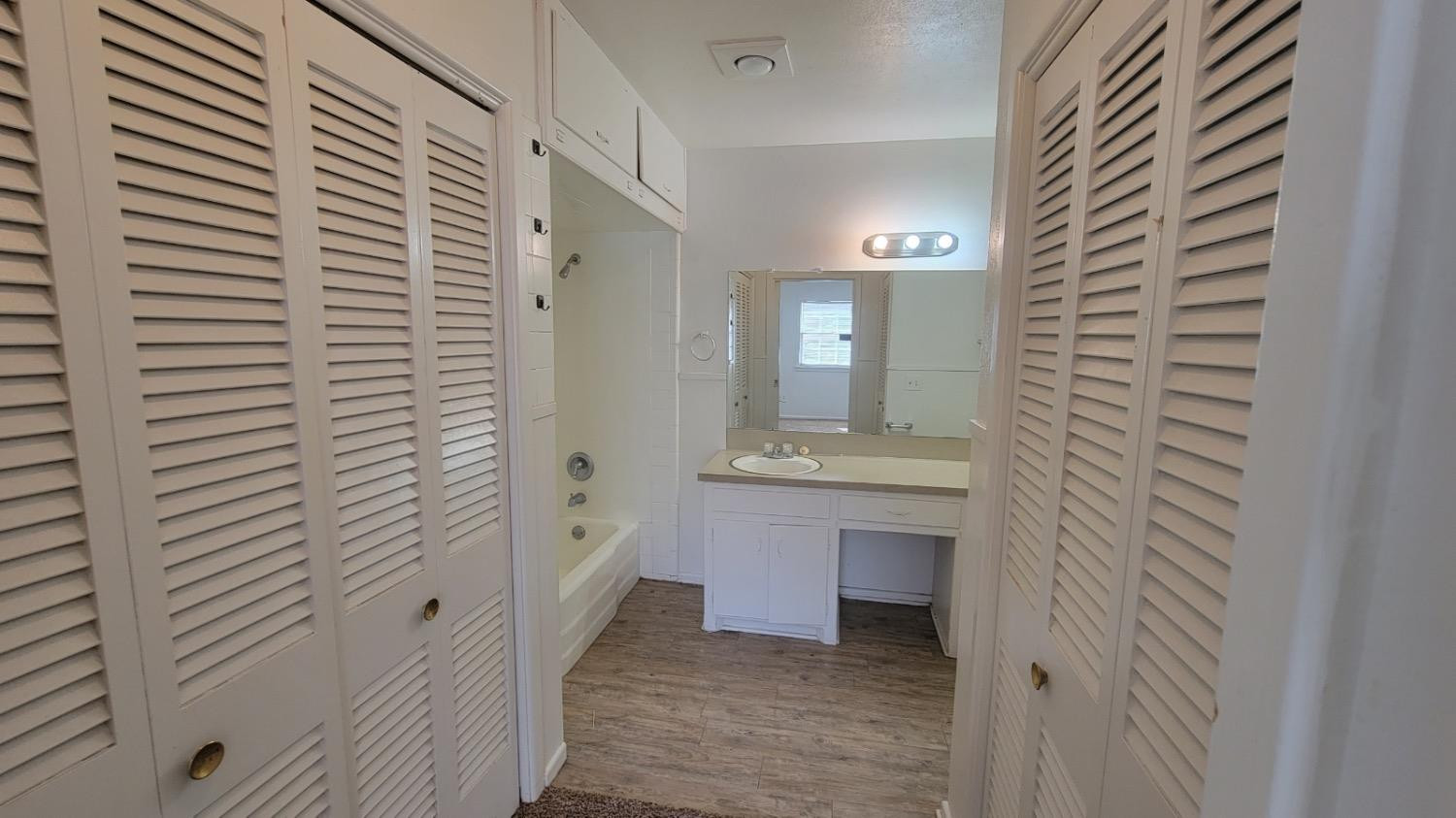 4205 50th Street, Unit A Lubbock, TX 79413 - Photo 5 of 10 a bathroom with a sink and a mirror
