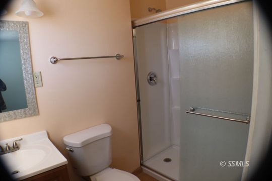 247 West Graaf Avenue Ridgecrest, CA 93555 - Photo 16 of 20 a bathroom with a shower and a toilet