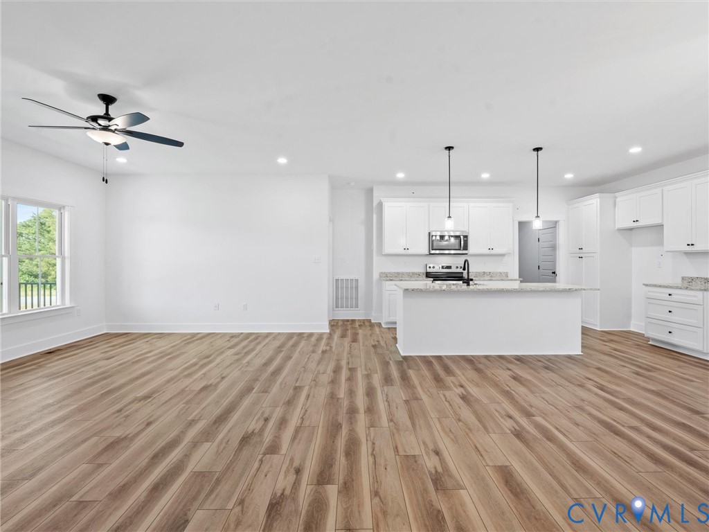 3289 Cumberland Road Cumberland, VA 23040 - Photo 11 of 29 a large kitchen with cabinets wooden floor and stainless steel appliances