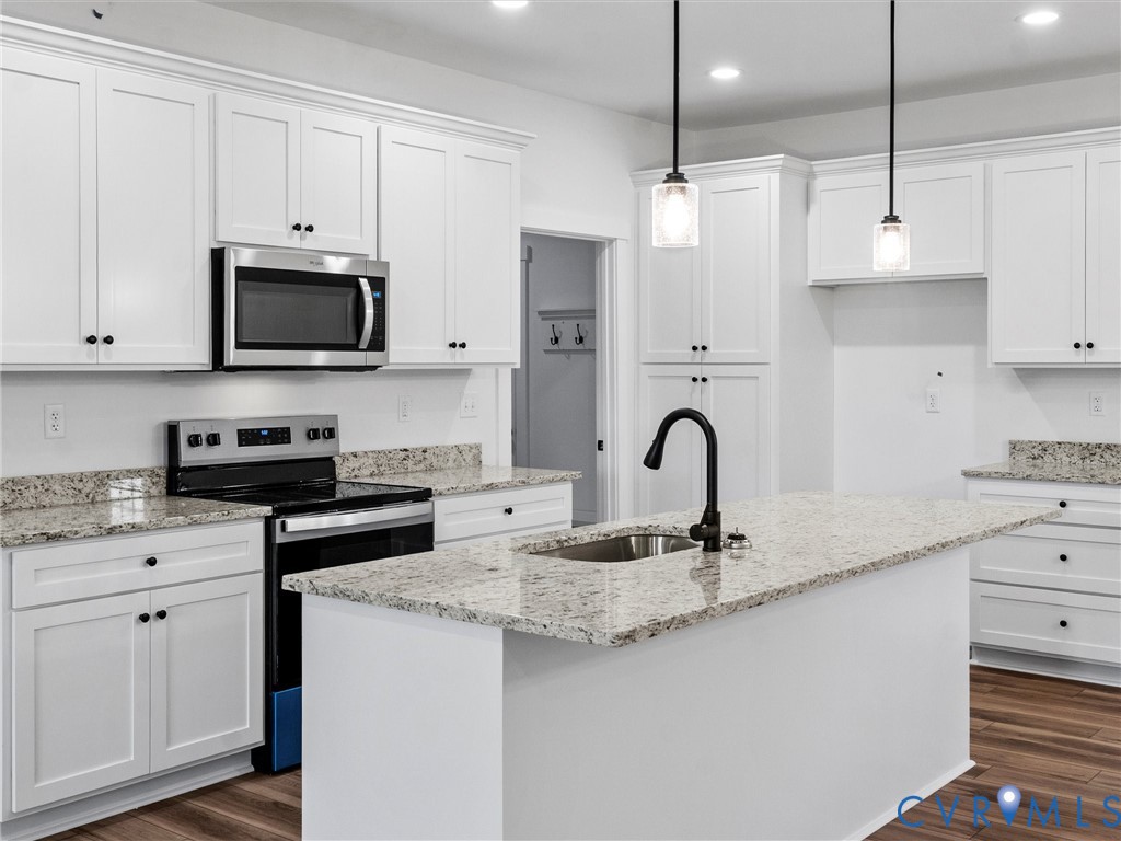 3289 Cumberland Road Cumberland, VA 23040 - Photo 13 of 29 a kitchen with granite countertop white cabinets and stainless steel appliances
