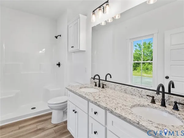 a bathroom with a granite countertop sink a toilet and bathtub
