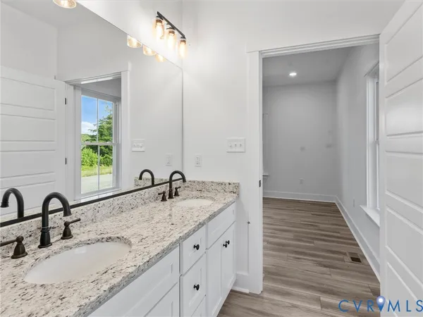 a bathroom with double sink and a mirror