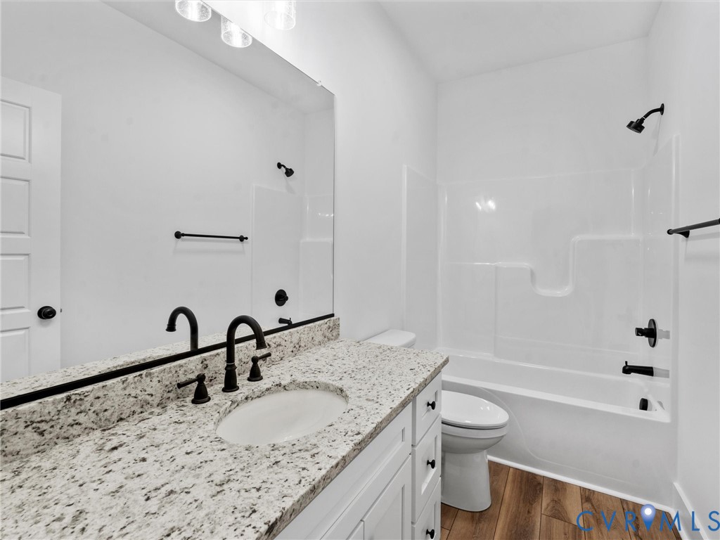 3289 Cumberland Road Cumberland, VA 23040 - Photo 23 of 29 a bathroom with a granite countertop sink a toilet and shower