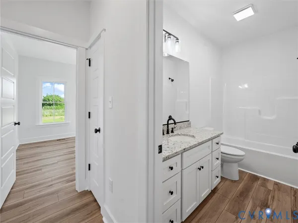 a bathroom with 2 sink toilet and a mirror