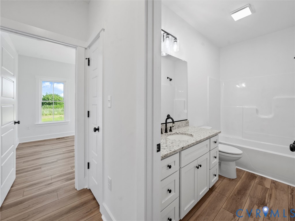 3289 Cumberland Road Cumberland, VA 23040 - Photo 24 of 29 a bathroom with 2 sink toilet and a mirror