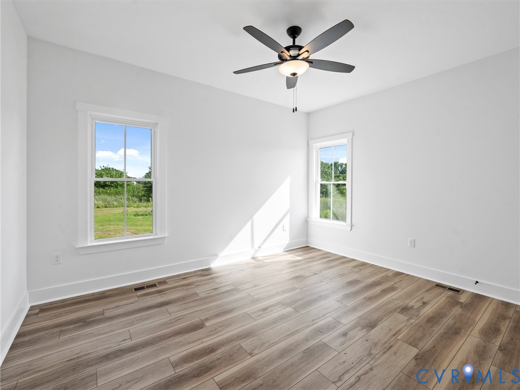 3289 Cumberland Road Cumberland, VA 23040 - Photo 25 of 29 a view of an empty room with wooden floor and a window