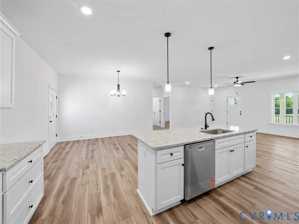 a view of a kitchen counter space a sink and wooden floor