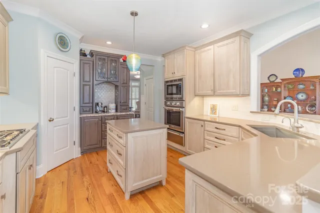 a kitchen with a sink stove and refrigerator