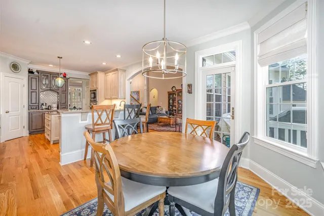 a view of a dining room with furniture and a chandelier