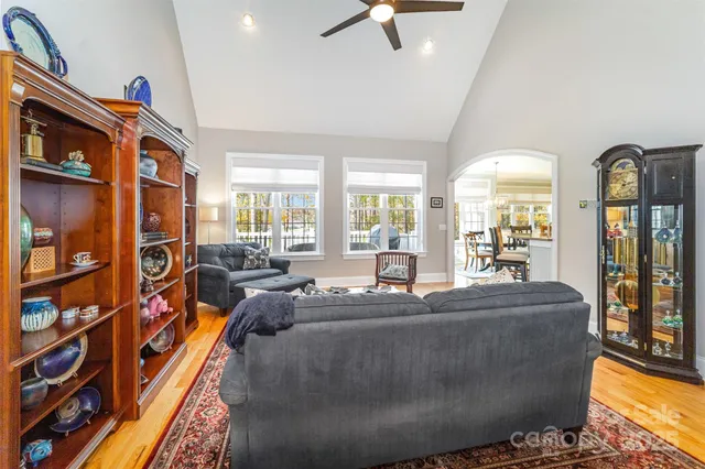 a living room with furniture fireplace and a window