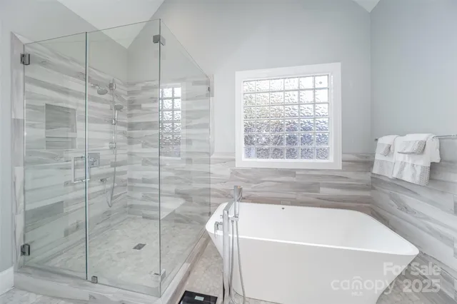 a bathroom with a tub and shower