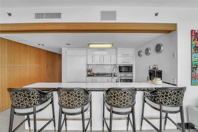 a kitchen with a dining table and chairs