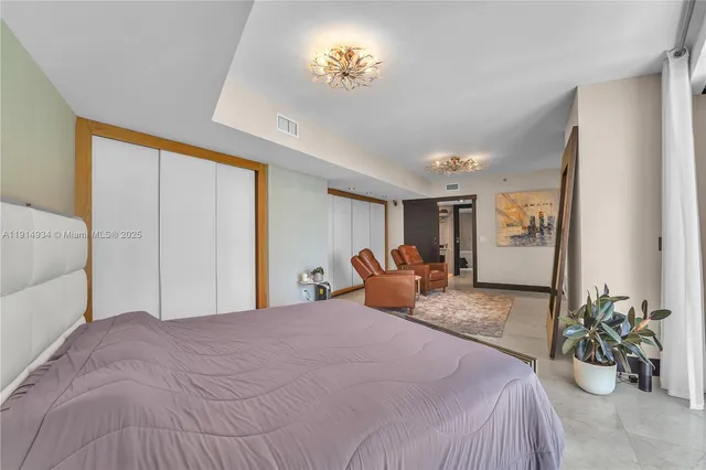 a bedroom with a bed and ceiling fan