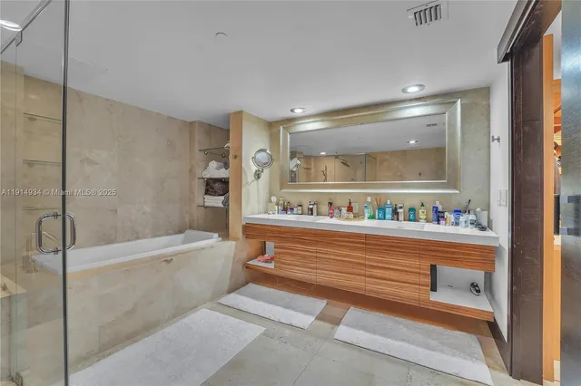 a bathroom with a bathtub and a shower