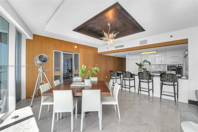 a dining room with furniture garden view and a large window