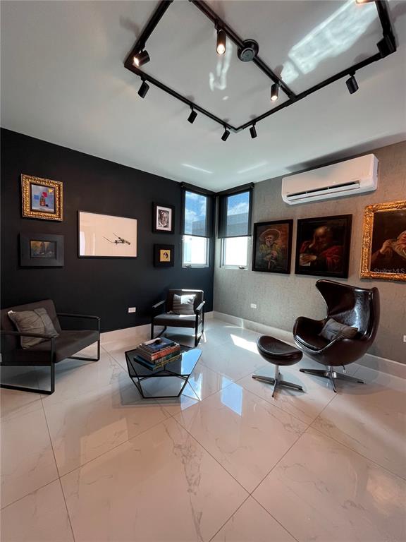 68 Riviera Village Bayamon, PR 00959 - Photo 9 of 14 a living room with furniture gym equipment and a ceiling fan