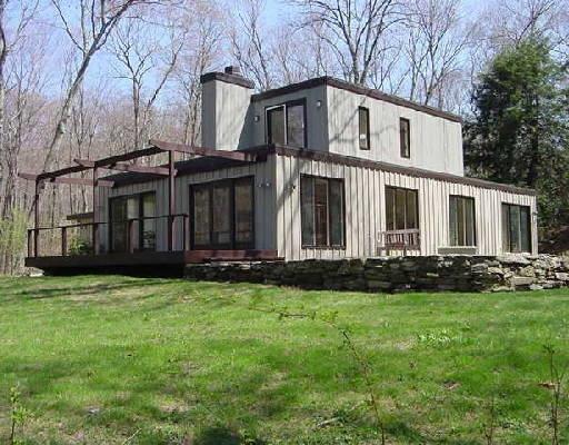 69 Nettleton Hollow Road Washington, CT 06793 - Photo 1 of 1 a front view of a house with a garden