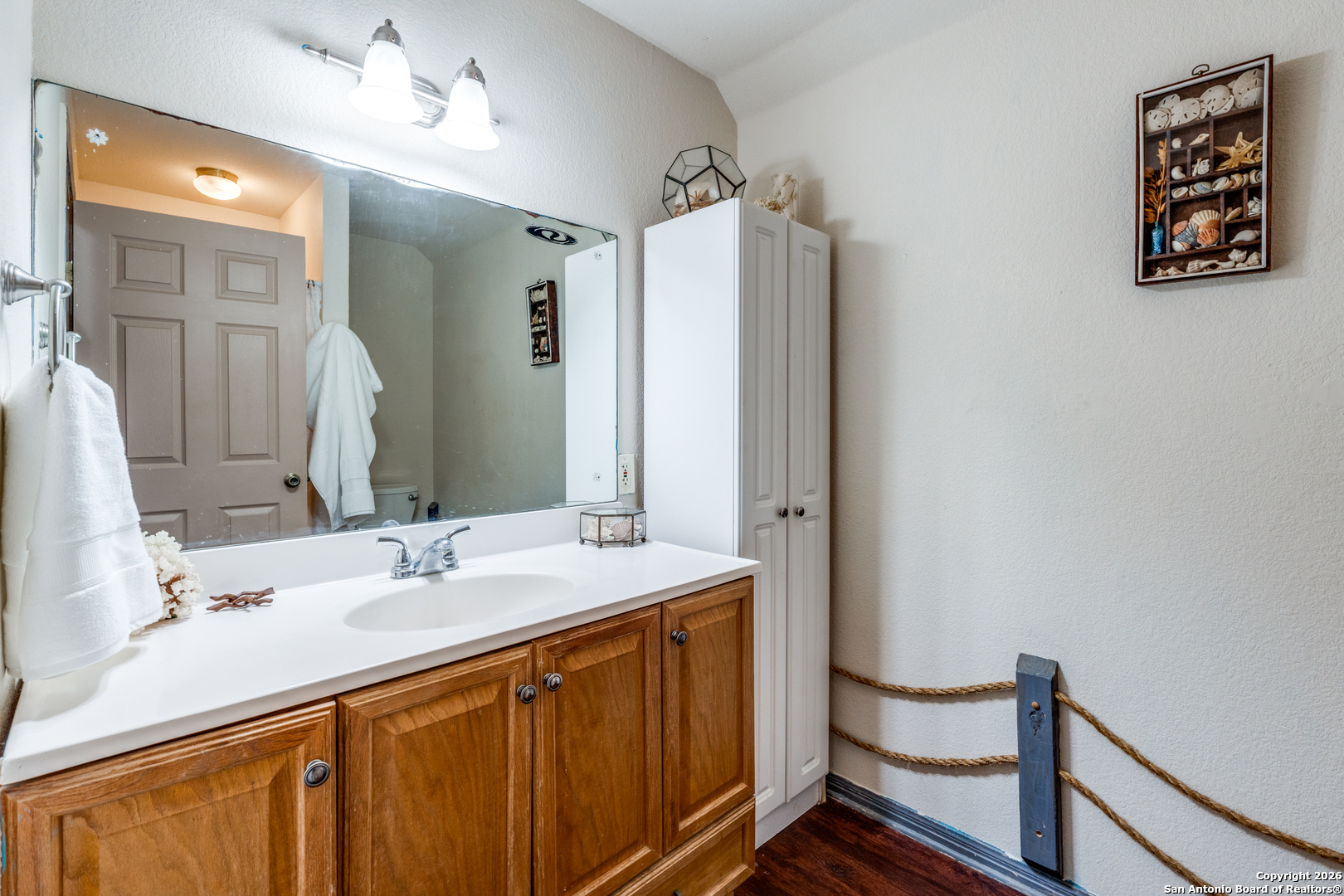 1609 Winding Creek Trail Spring Branch, TX 78070 - Photo 11 of 20 a bathroom with a sink vanity and a mirror