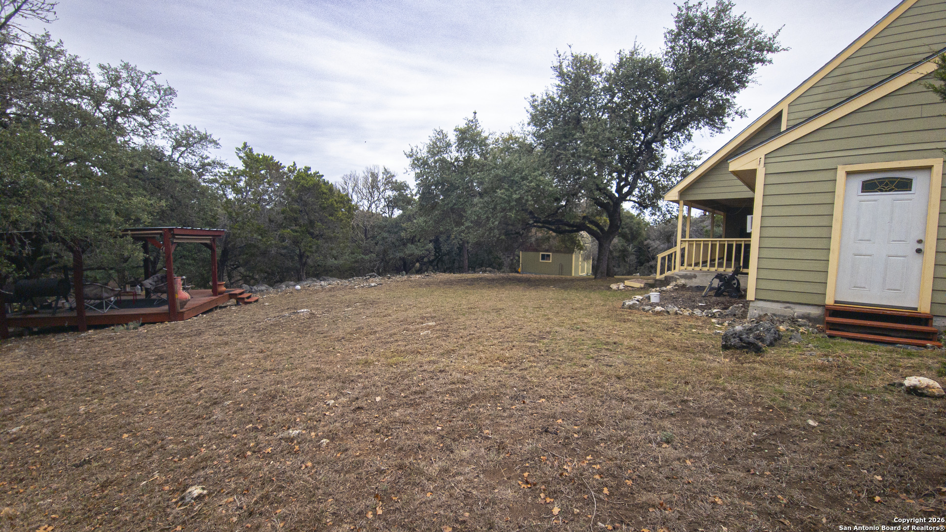 1609 Winding Creek Trail Spring Branch, TX 78070 - Photo 18 of 20 a view of a backyard with sitting area