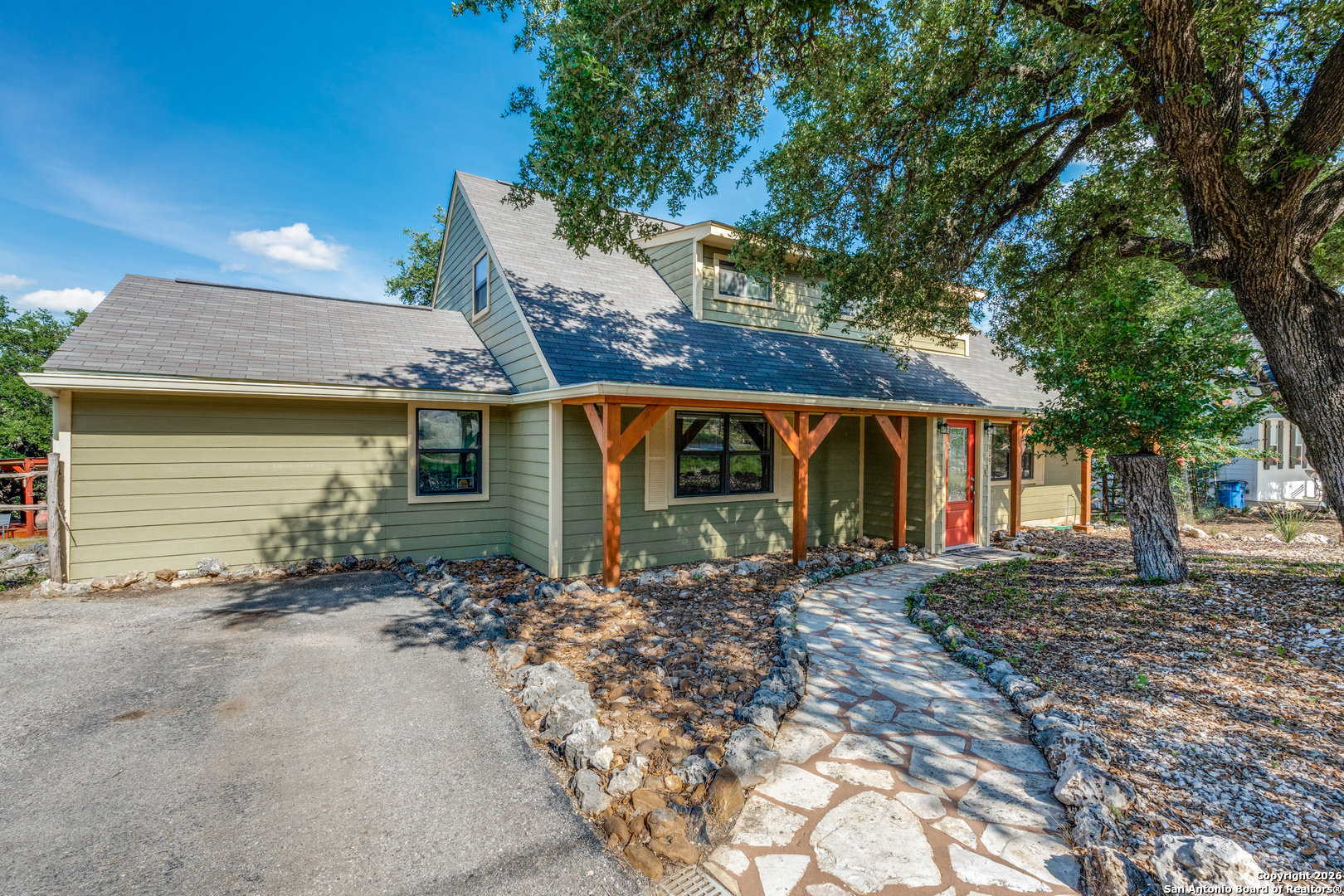 1609 Winding Creek Trail Spring Branch, TX 78070 - Photo 3 of 20 a front view of a house with garden