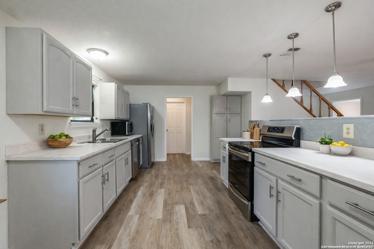 1609 Winding Creek Trail Spring Branch, TX 78070 - Photo 7 of 20 a kitchen with a sink a counter top space stainless steel appliances and cabinets