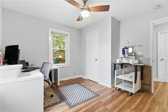 a view of a livingroom with workspace and a window