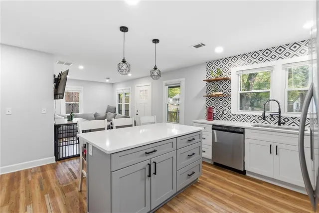 a kitchen with sink stove and cabinets