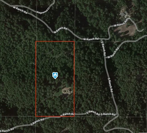 an aerial view of a house with yard and patio