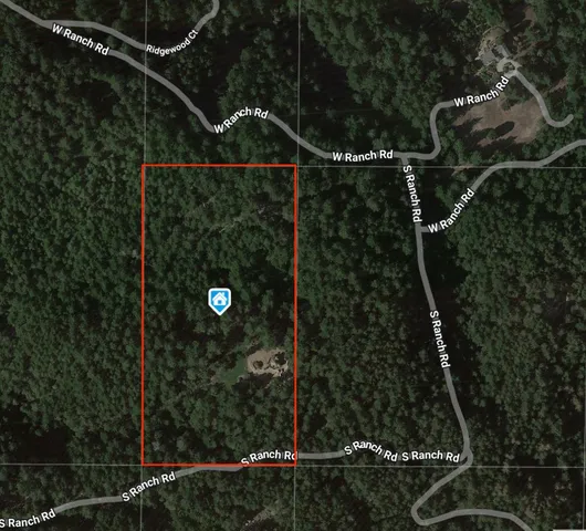 an aerial view of a house with yard and patio