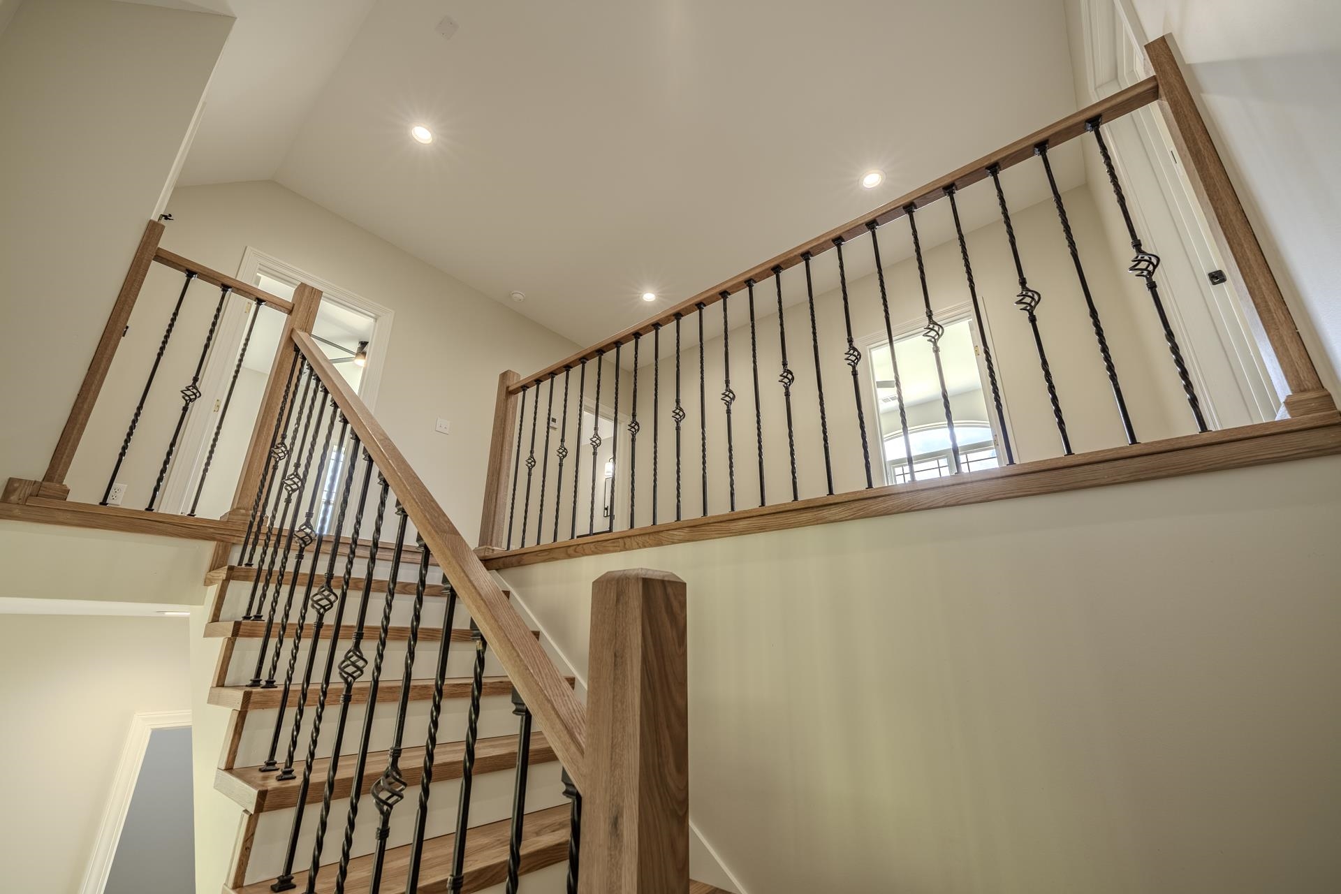 851 Rivers Edge Drive Bath Springs, TN 38311 - Photo 21 of 39 Wood-finish staircase with wrought iron balusters and natural wood handrails