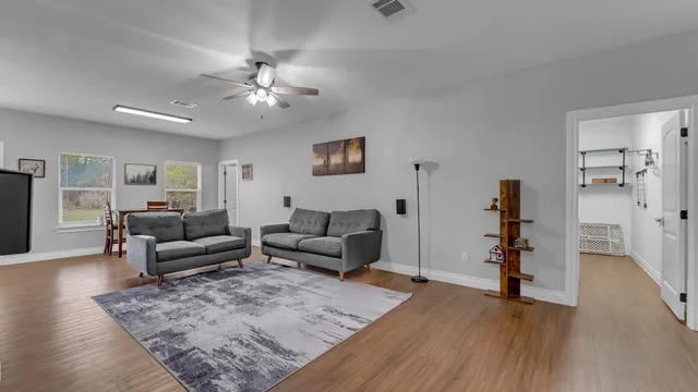 a living room with furniture and wooden floor