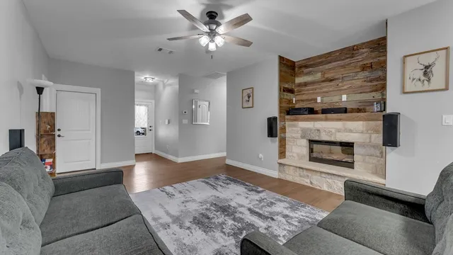 a living room with furniture and a fireplace