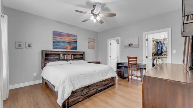 a bedroom with a bed and wooden floor