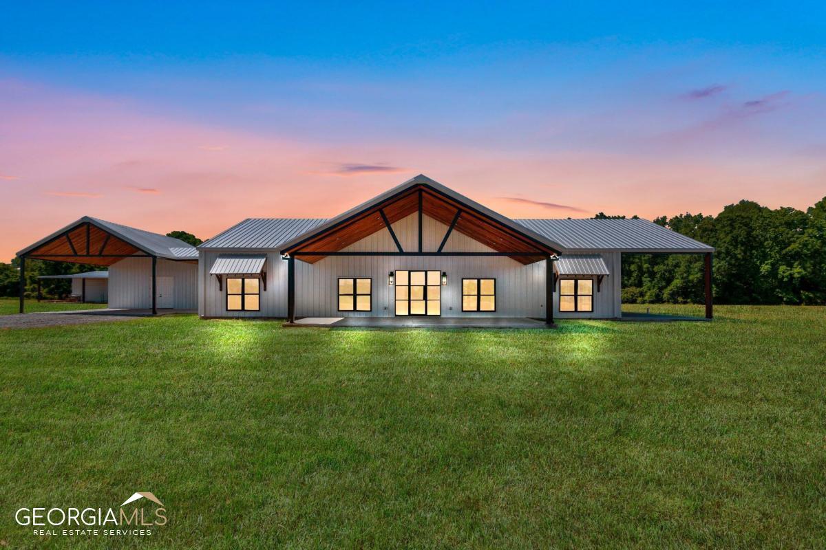 1528 Alma Road Odum, GA 31555 - Photo 1 of 1 a view of a big yard with a house in the background