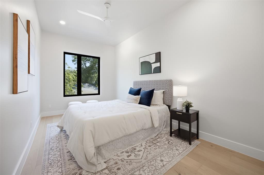 4615 Rusk Avenue Dallas, TX 75204 - Photo 33 of 40 a bedroom with a bed and a night stand