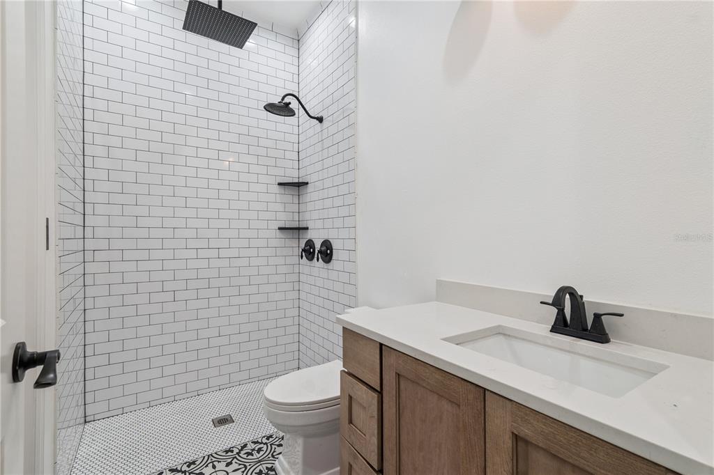 345 Cypress Isles Road Osteen, FL 32764 - Photo 23 of 41 a bathroom with a sink a toilet and shower