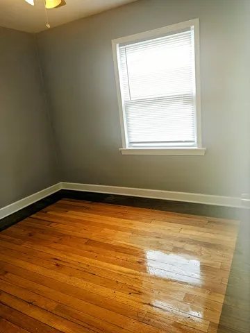 a view of a room with wooden floor and natural light