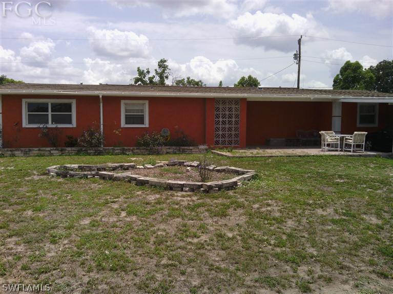 504 Penn Road West Lehigh Acres, FL 33936 - Photo 2 of 7 a view of a house with a yard