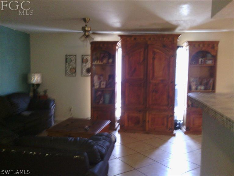 504 Penn Road West Lehigh Acres, FL 33936 - Photo 3 of 7 a living room with furniture and a chandelier