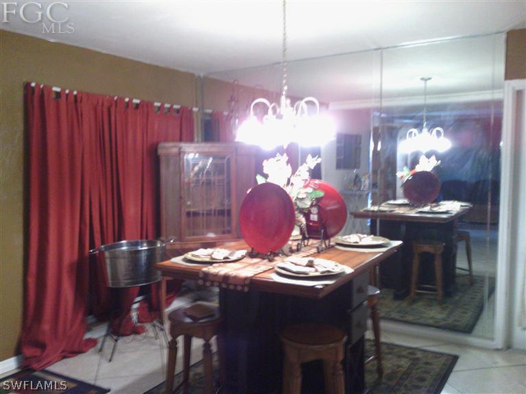 504 Penn Road West Lehigh Acres, FL 33936 - Photo 7 of 7 a dining room with furniture and chandelier