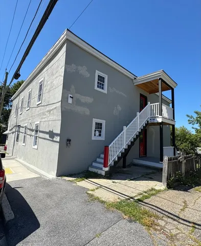 a front view of a house with a road