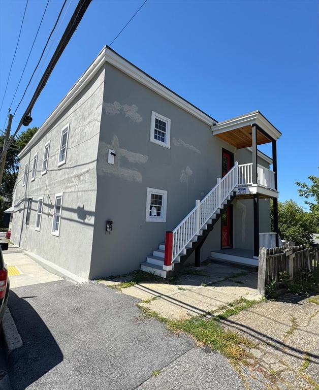 56 Whitcomb Street Webster, MA 01570 - Photo 16 of 18 a front view of a house with a road