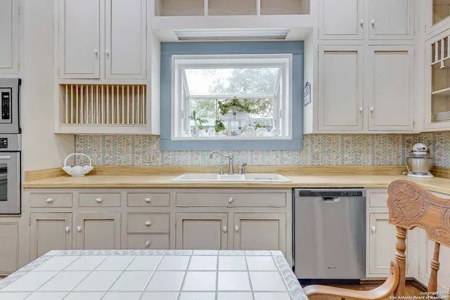 a kitchen with a sink cabinets and window