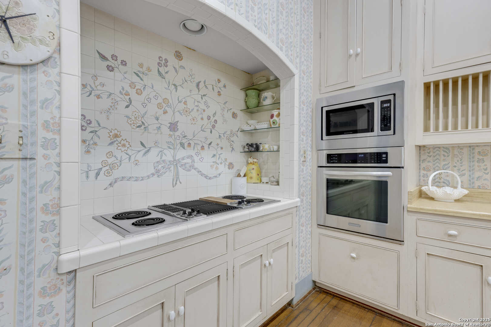 1201 10th Street Hondo, TX 78861 - Photo 15 of 46 a kitchen with white cabinets stainless steel appliances and wooden floor