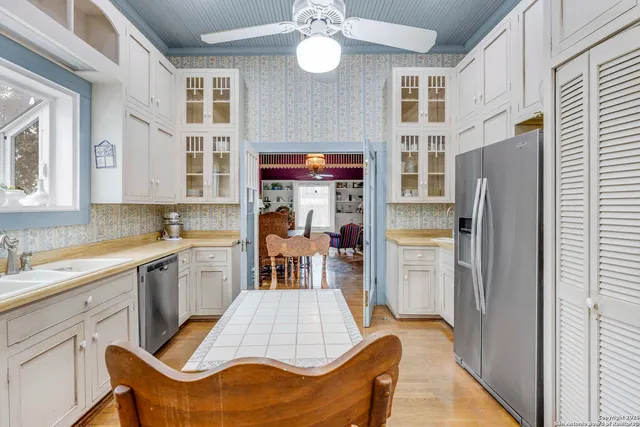 a kitchen with stainless steel appliances kitchen island granite countertop a refrigerator and a sink