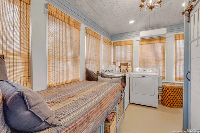 a bed room with a bed and a chair