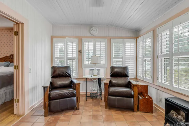 a living room with furniture and floor to ceiling windows