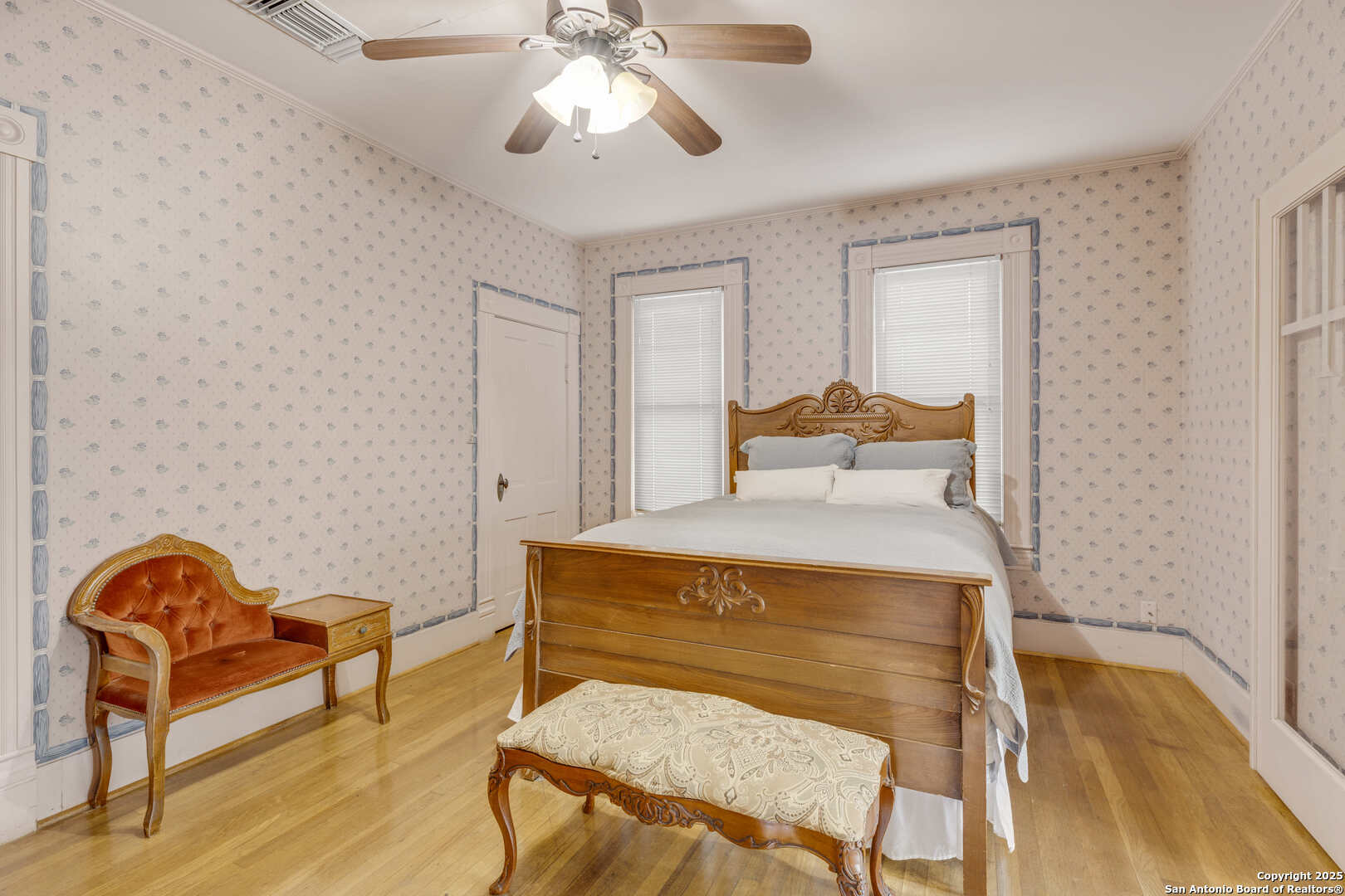 1201 10th Street Hondo, TX 78861 - Photo 25 of 46 a bedroom with a bed and wooden floor