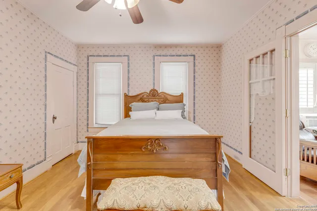 a bedroom with a bed and a window